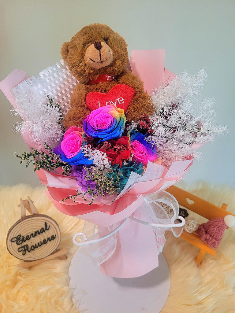 Rainbow Preserved Roses Bouquet With Elegant Pink Wrapper and Brown Care Bear. Same Day Delivery.