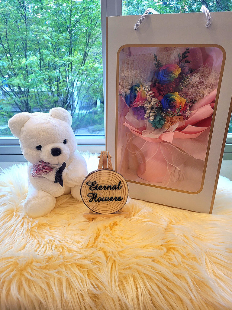 Rainbow Preserved Roses Bouquet With Elegant Pink Wrapper & Cute Teddy Bear. Same Day Delivery.