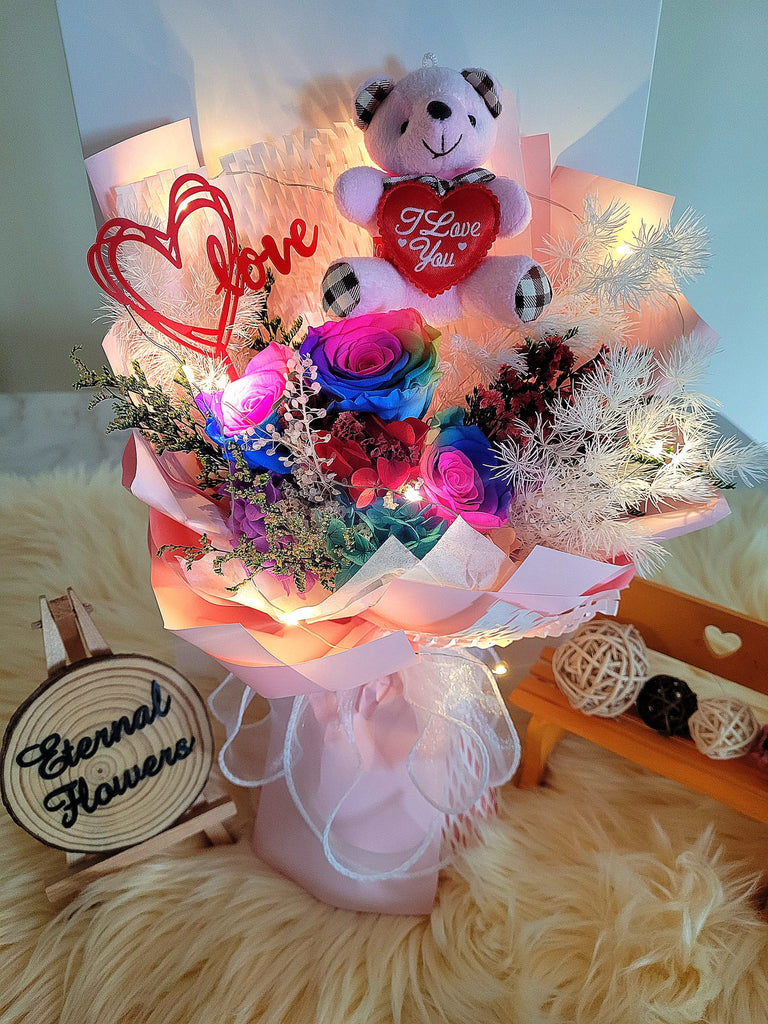 Valentine Special. Rainbow Preserved Roses Bouquet With Elegant Pink Wrapper & I Love You Bear. Same Day Delivery.